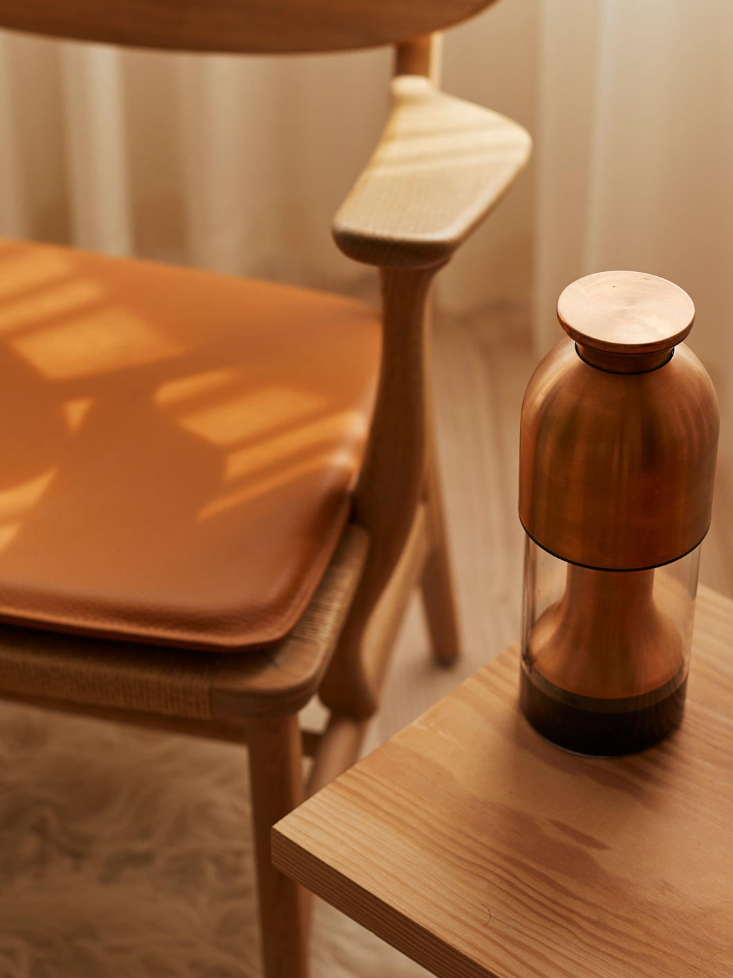 eto wine decanter in copper satin finish on side table in warm minimal home