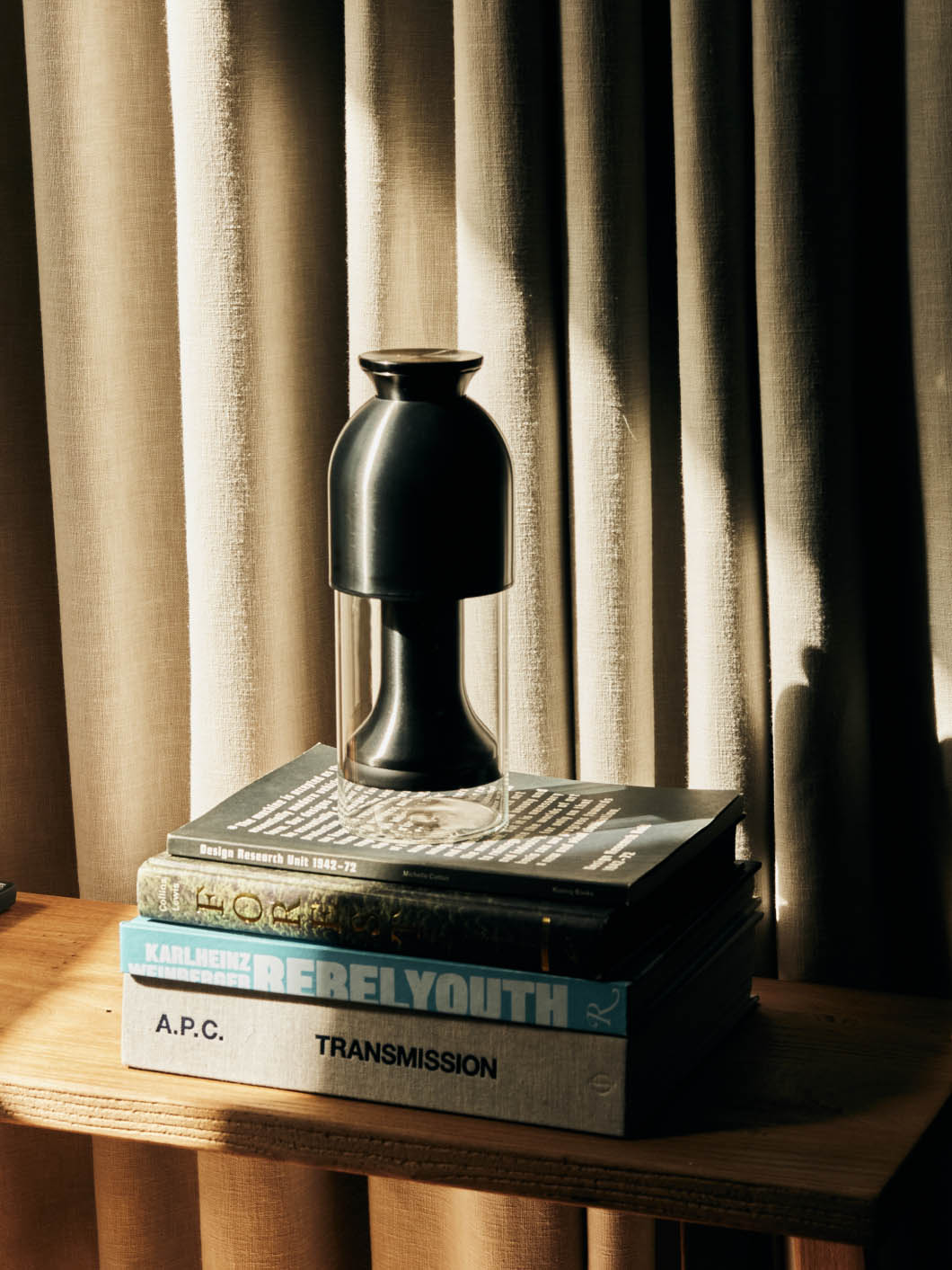 An eto graphite satin decanter on a stack of coffee table books